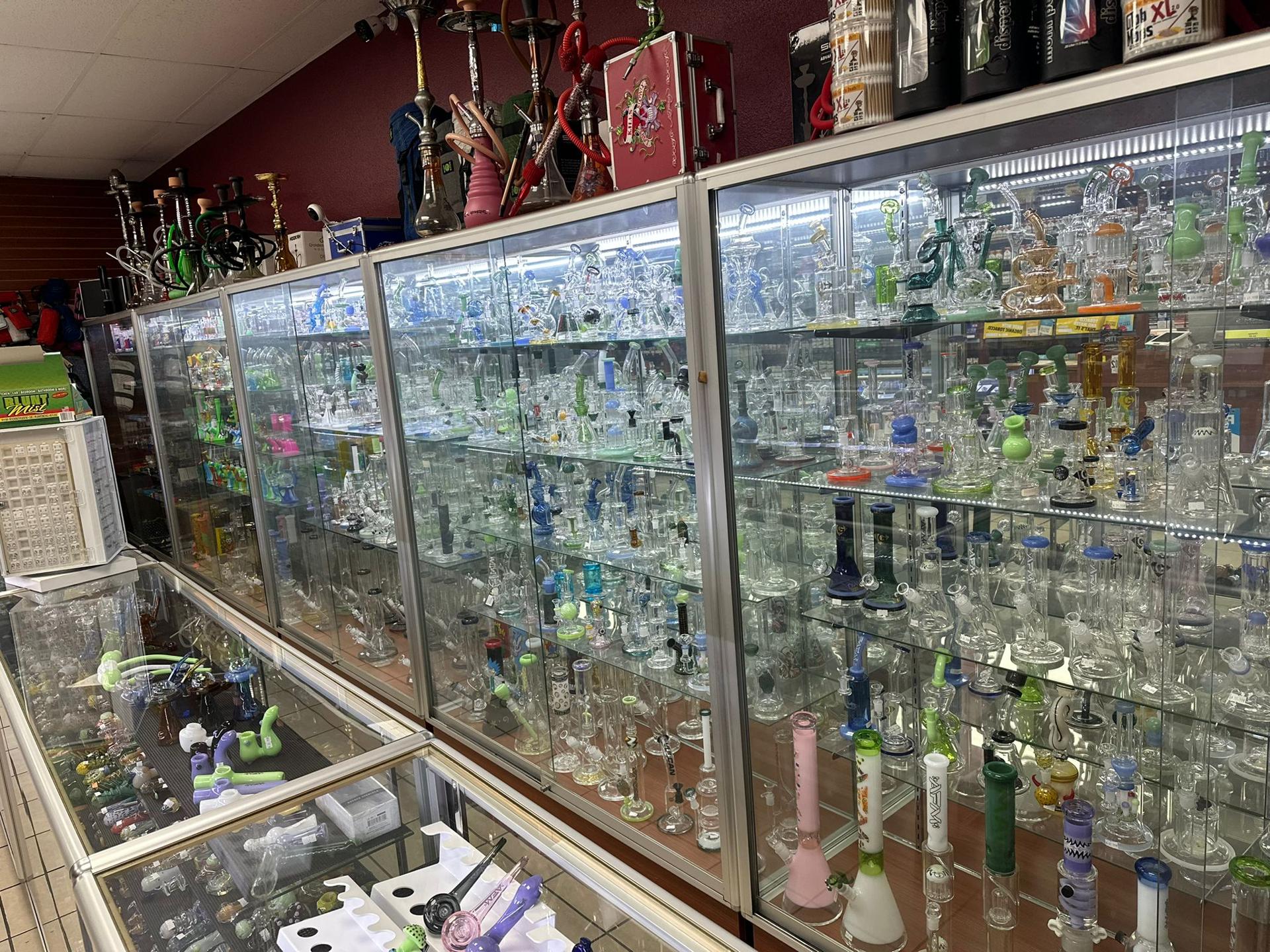 Well-organized interior of Sam's Smoke & Vape with display cases and product walls