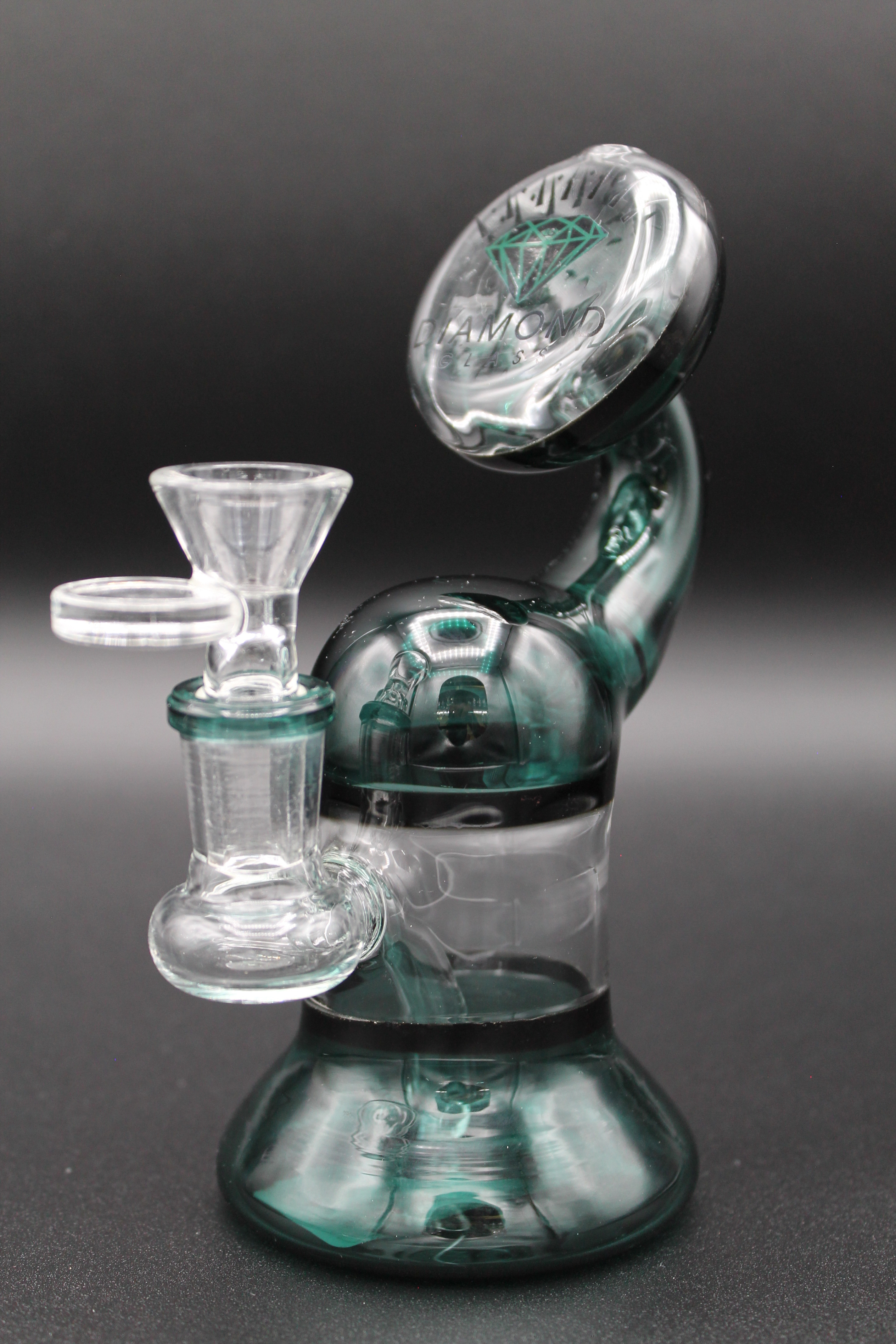Glass smoking device with diamond logo and intricate clear and teal design